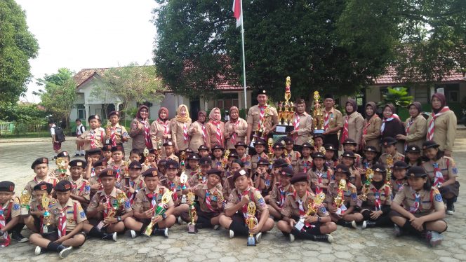 
 Foto RIA
Caption : Kepala SDN 1 Madukoro Misluna(tengah), para Guru dan Murid Pramuka saat menunjukkan piala hasil lomba Juara Pramuka, Selasa (18/6).  