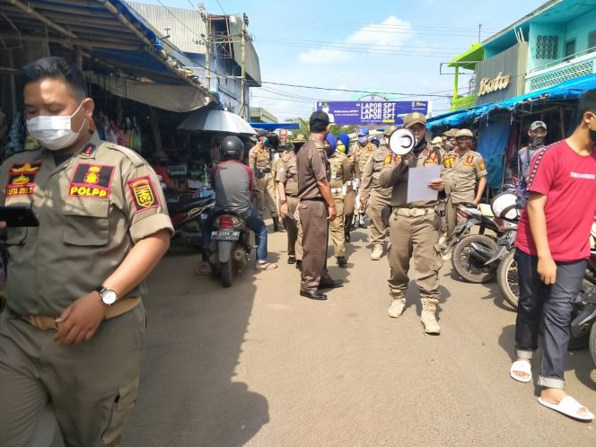 
 Tampak anggota Sat Pol-PP Provinsi Lampung dan Lampura saat menyambangi pedagang dan pembeli di Pasar Pagi Kotabumi.
