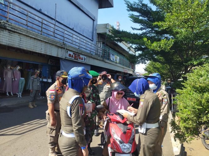 
 caption : Tampak anggota Satpol-PP bersama TNI dan Polri saat melakukan penertiban ASN yang kedapatan berkeliaran saat jam kerja berlangsung, Selasa(12/4).
